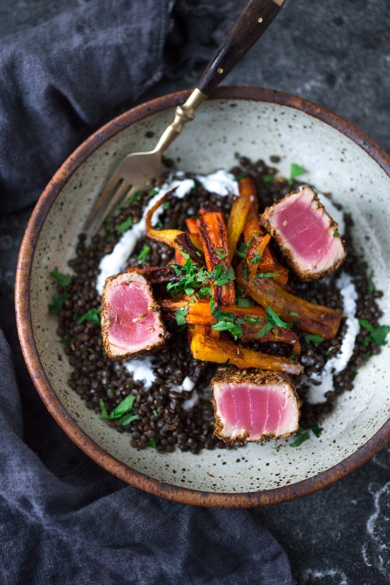 Seared Ahi served over Moroccan Lentils with roasted baby carrots, fresh herbs and yogurt drizzle. #searedahi #lentils 