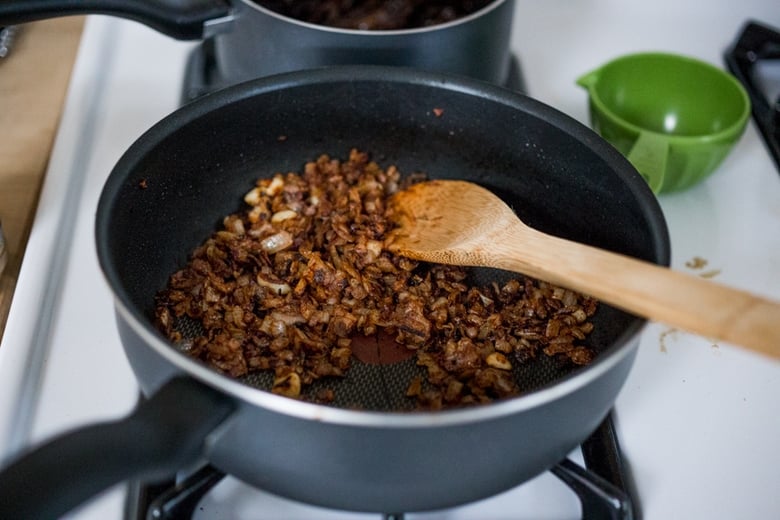 Stuffed Poblano Chili with black beans, quinoa, optional goat cheese- topped with a dark, complex and luscious Mole Negro Sauce. | www.feastingathome.com