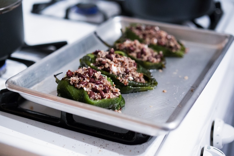 Stuffed Poblano Chili with black beans, quinoa, optional goat cheese- topped with a dark, complex and luscious Mole Negro Sauce. | www.feastingathome.com