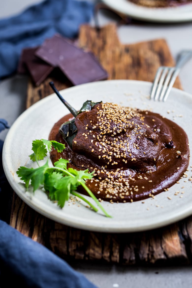 Stuffed Poblano Chili with black beans, quinoa, goat cheese- topped with a dark complex Mole Negro Sauce. | www.feastingathome.com