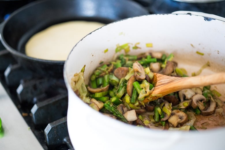 Baked Crepes with Asparagus, Leeks, Mushrooms and Goat Cheese- make ahead then bake right before serving. | www.feastingathome.com