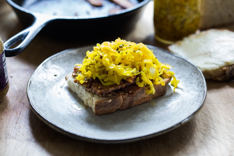 Tempeh Reuben Sandwich with Smoked Mozzarella and Turmeric Sauerkraut ( or sub regular!). A tasty, hearty, delicious vegetarian sandwich! | www.feastingathome.com