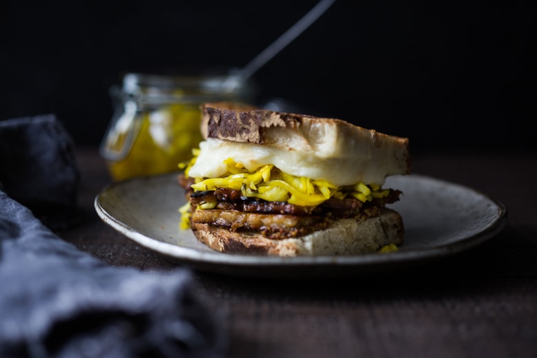 Tempeh Reuben Sandwich with Smoked Mozzarella and Turmeric Sauerkraut ( or sub regular!). A tasty, hearty, delicious vegetarian sandwich! | www.feastingathome.com