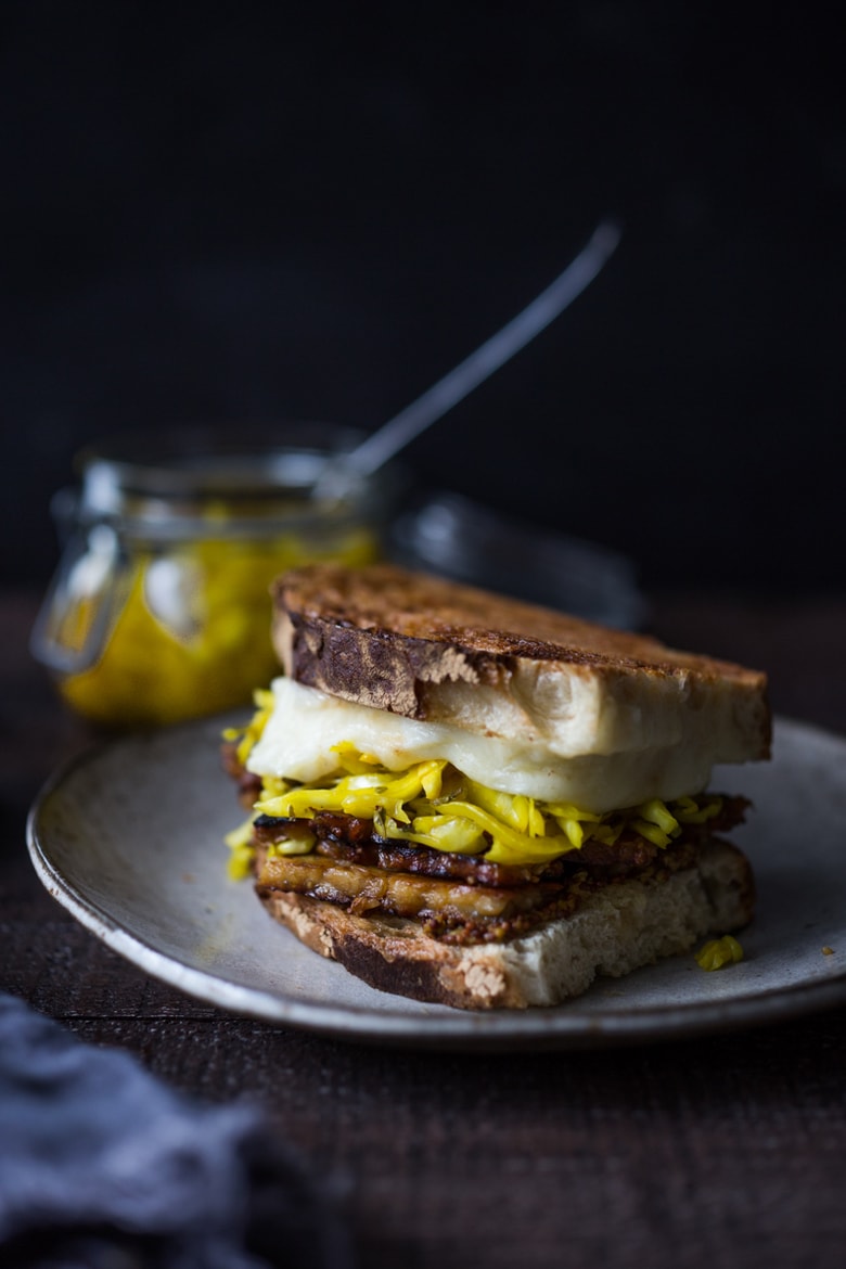 Tempeh Reuben Sandwich with Smoked Mozzarella and Turmeric Sauerkraut ( or sub regular!). A tasty, hearty, delicious vegetarian sandwich! | www.feastingathome.com