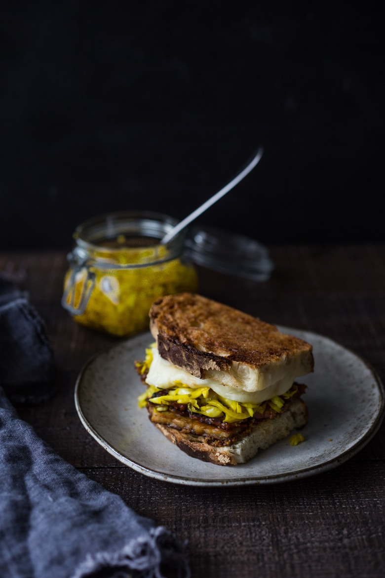 Tempeh Reuben Sandwich with Smoked Mozzarella and Turmeric Sauerkraut ( or sub regular!). A tasty, hearty, delicious vegetarian sandwich! | www.feastingathome.com