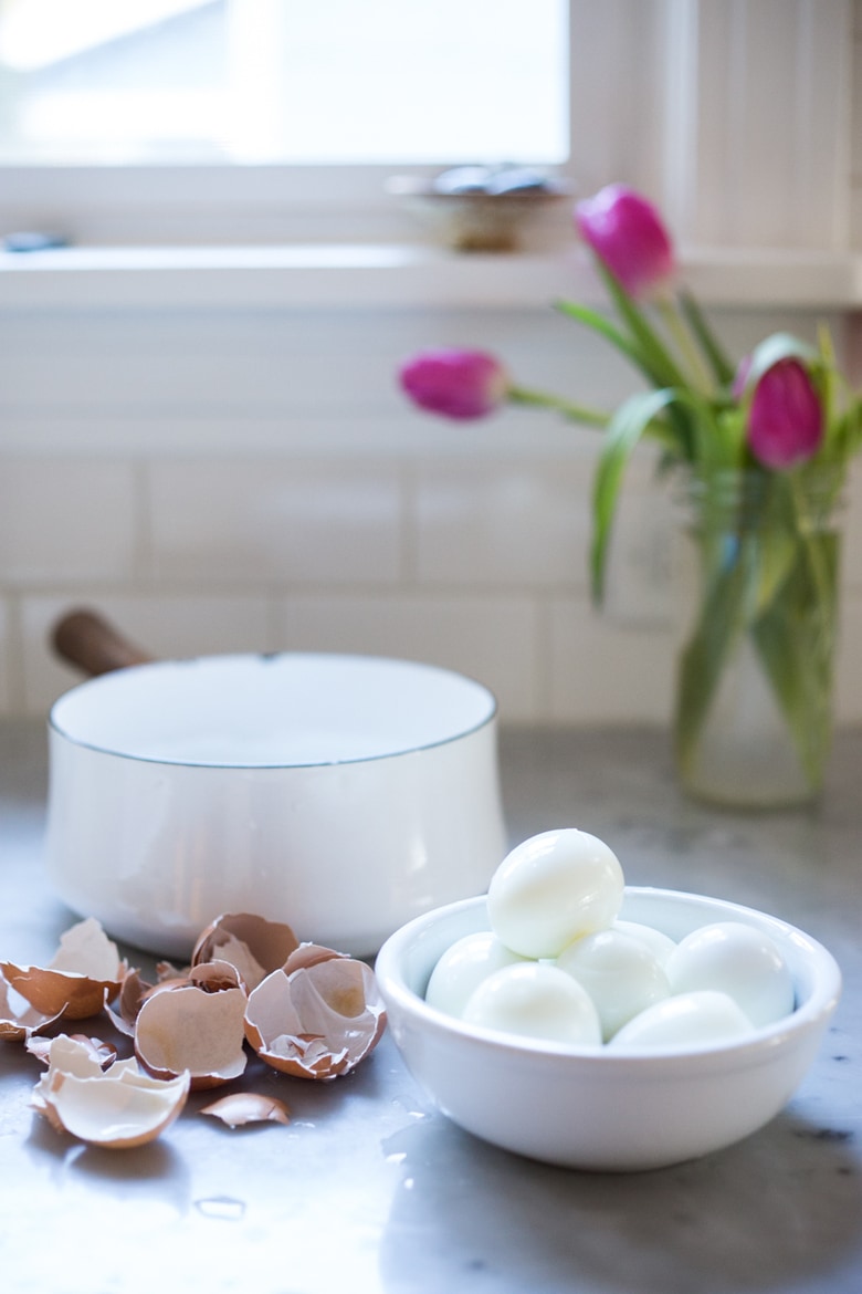 Simple Boiled Eggs with olive oil, herbs and pickled shallots- a fast and tasty way to use up all your Easter Eggs or feed a crowd. | www.feastingathome.com