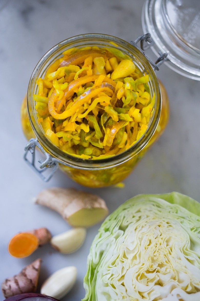 How to make Turmeric Sauerkraut- a small-batch recipe that can be put together in 10 minutes, and sits on the counter for 3-5 days. | #kraut #fermented #sauerkraut www.feastingathome.com