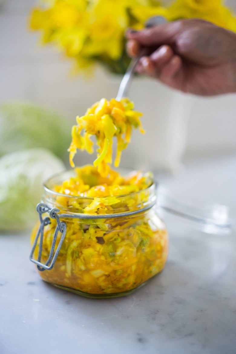 How to make Turmeric Sauerkraut- a small-batch recipe that can be put together in 10 minutes, and sits on the counter for 3-5 days. | #kraut #fermented #sauerkraut www.feastingathome.com