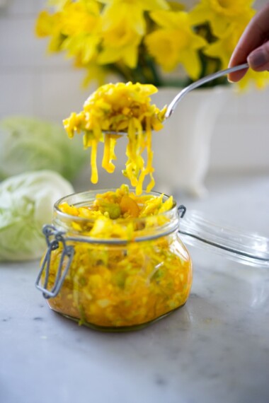 How to make Turmeric Sauerkraut- a small-batch recipe that can be put together in 10 minutes, and sits on the counter for 3-5 days. | #kraut #fermented #sauerkraut www.feastingathome.com