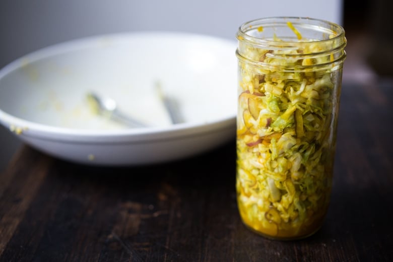 Simple Turmeric Sour Kraut- a small-batch recipe that can be put together in 10 minutes, and sits on the couture for 3-5 days. | www.feastingathome.com