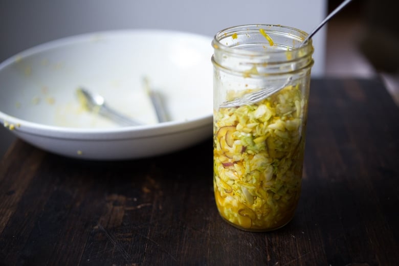 Simple Turmeric Sour Kraut- a small-batch recipe that can be put together in 10 minutes, and sits on the couture for 3-5 days. | www.feastingathome.com