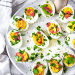 Quick and Easy Hard boiled eggs with olive oil, fresh herbs and pickled shallots, a simple, make ahead brunch recipe that is  perfect for gatherings and potlucks. Think of these like deviled eggs but in ½ the time! #deviledeggs #hardboiledeggs #boiledeggs #brunchrecipe