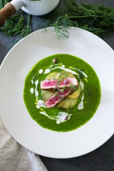 A spring-inspired recipe for Seared Ahi with dill sauce, yogurt and chive blossoms, a Nordic-style dish highlighting spring potatoes. Feel free to sub-halibut or salmon! 
