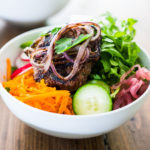 Burger in a Bowl- grilled ( beef, lamb, turkey or veggie) burger served over a mound of greens with fresh veggies and your choice of dressing. A tasty healthier way to serve a burger! | www.feastingathome.com
