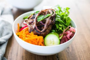 Burger in a Bowl- grilled ( beef, lamb, turkey or veggie) burger served over a mound of greens with fresh veggies and your choice of dressing. A tasty healthier way to serve a burger! | www.feastingathome.com