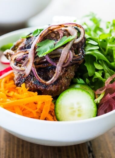Burger in a Bowl- grilled ( beef, lamb, turkey or veggie) burger served over a mound of greens with fresh veggies and your choice of dressing. A tasty healthier way to serve a burger! | www.feastingathome.com