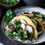 Greek lamb Tacos with Minted Yogurt Sauce, cucumber, radish, feta and an herb-caper drizzle- a feast for the senses! | www.feastingathome.com