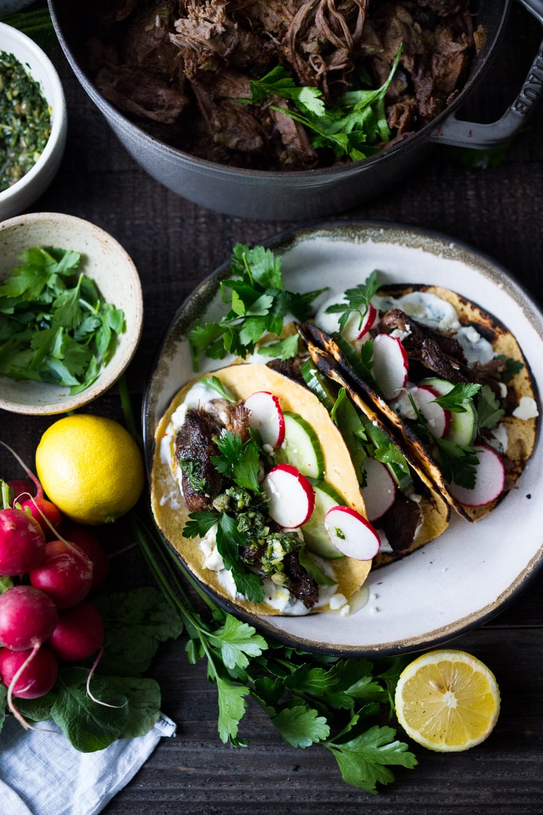 Greek lamb Tacos with Minted Yogurt Sauce, cucumber, radish, feta and an herb-caper drizzle- a feast for the senses! | www.feastingathome.com