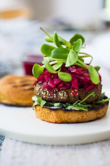 Sprouted Lentil Burgars- grillable, vegan and gluten free adaptable. Topped with picked beets. | www.feastingathome.com