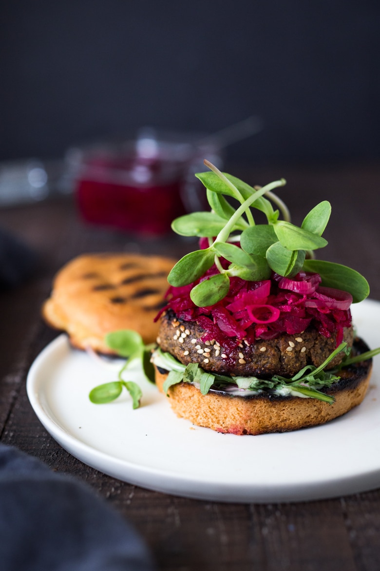 Sprouted Lentil Burgers- grillable, vegan and gluten-free adaptable. Super healthy and delicious, packed with living nutrients! Topped with quick picked beets. | www.feastingathome.com