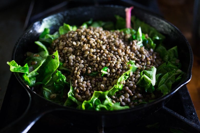 Warm Lentils with wilted chard, roasted beets, goat cheese and spring herbs. A simple tasty vegetarian meal! | www.feastingathome.com