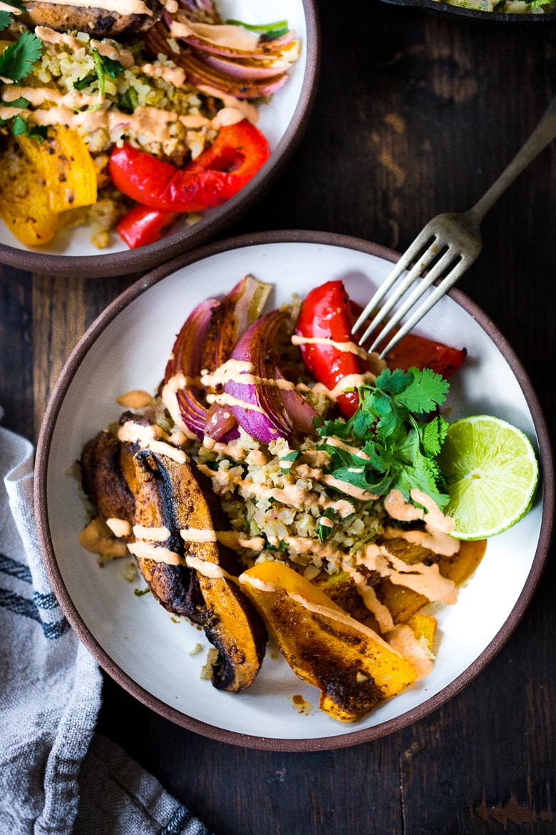 Vegan Fajitas with Cauliflower Rice are loaded up with healthy veggies that are lathered in flavorful Mexican Marinade and served over cauliflower "rice". The best thing? You can bake it all on a sheet pan with just 15 minutes of hands-on time. Keep it vegan or add chicken!