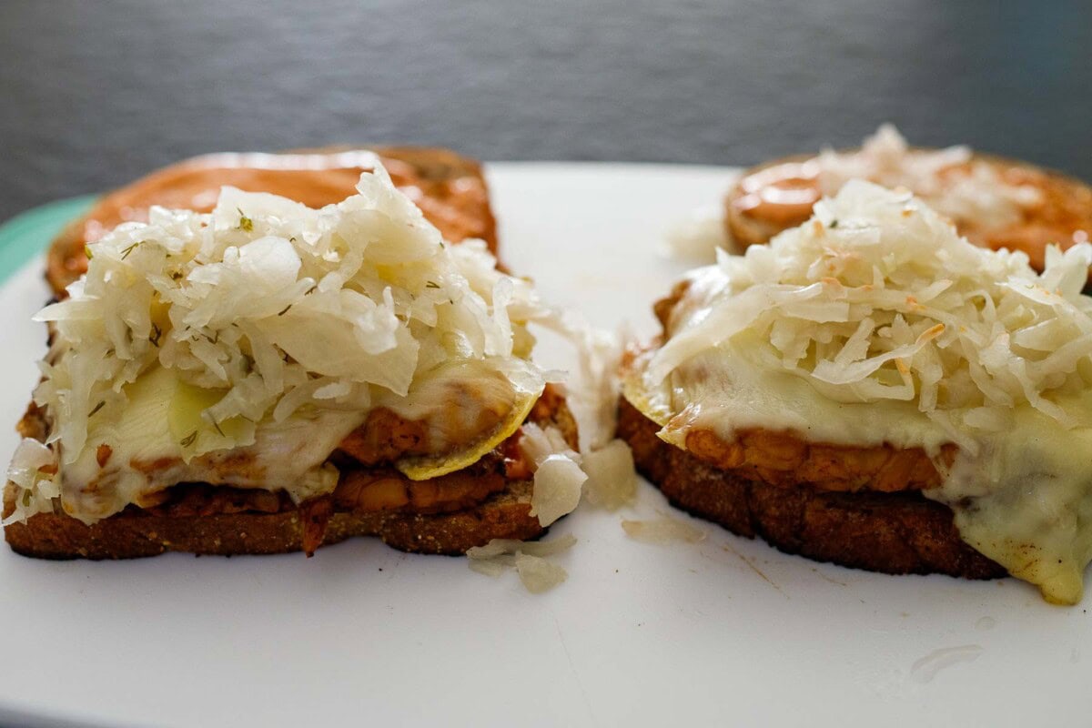 assembling the tempeh reuben sandwich. 