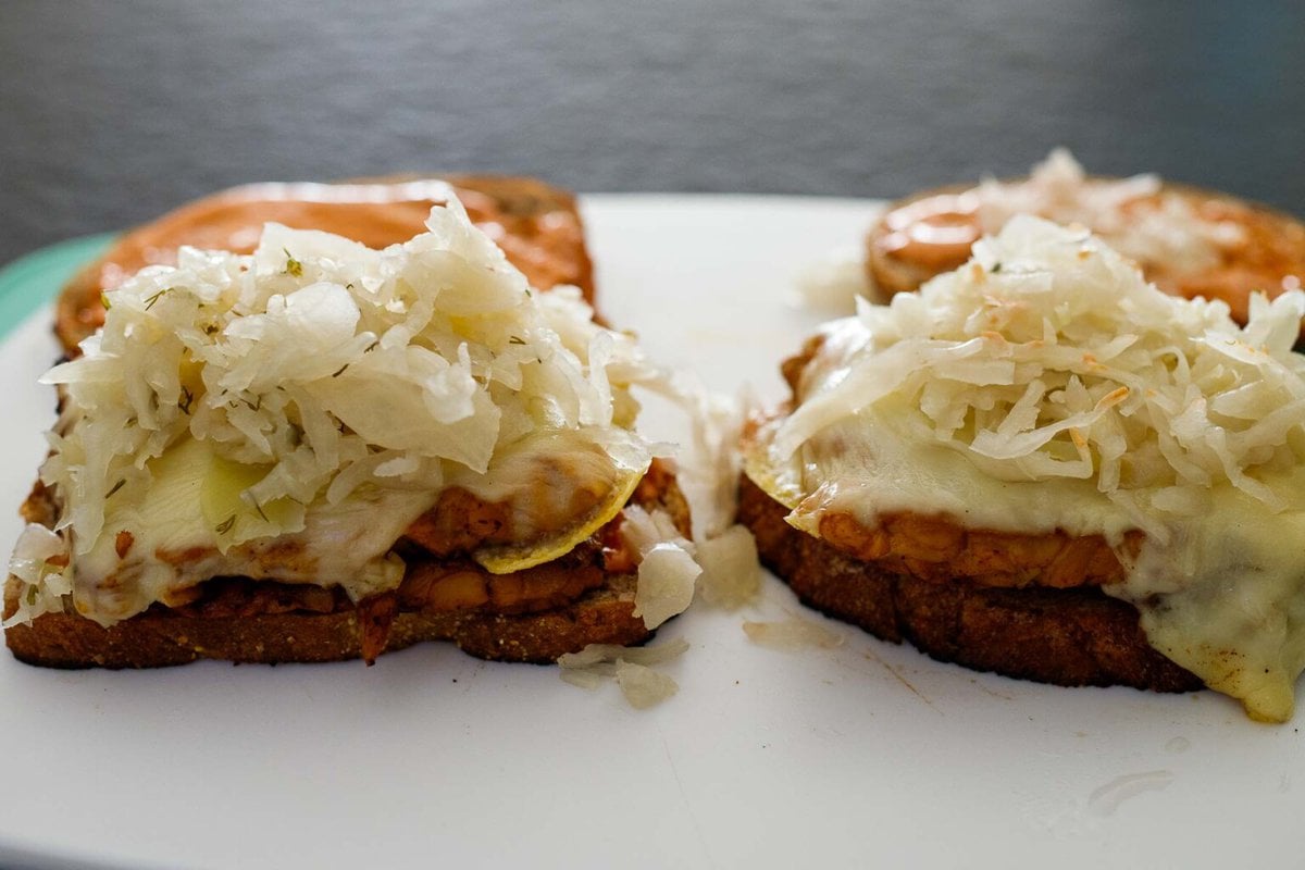assembling the tempeh reuben sandwich.