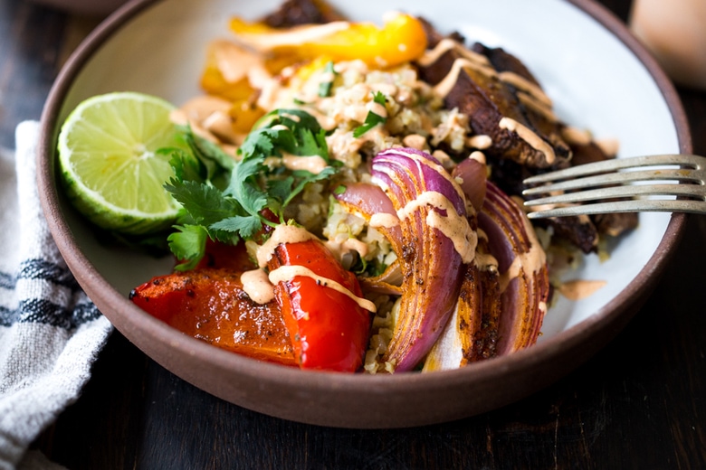 Veggie Fajita Bowl with Cilantro Cauliflower Rice- a vegan gluten free meal that only takes 15 minutes of hands-on time! Keep it vegan or add chicken. | www.feastingathome.com