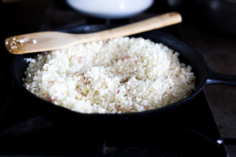 Cilantro Cauliflower Rice- a vegan gluten free meal that only takes 15 minutes of hands-on time! Keep it vegan or add chicken. | www.feastingathome.com