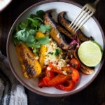 Sheet-Pan Veggie Fajita Bowl with Cilantro Lime Cauliflower Rice- a fast weeknight meal that is vegan and gluten free.
