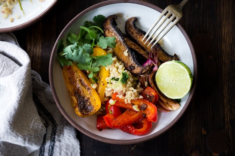 Vegan Fajita Bowl with Portobellos and Cilantro Cauliflower Rice- a vegan gluten free meal that only takes 15 minutes of hands-on time! Keep it vegan or add chicken. | www.feastingathome.com