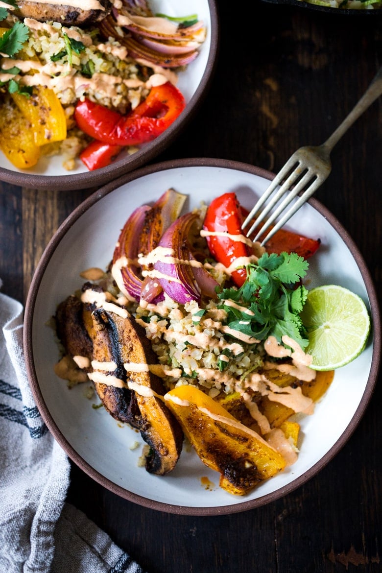 Our 20 BEST Buddha Bowls!|Vegan Fajita Bowls with Roasted Portobello Mushrooms and peppers served over Cilantro Lime Cauliflower Rice- a fast sheet-pan dinner that is perfect for weeknights! #fajitabowl #veganfajita #fajitas #sheetpandinner #veganbowls #buddhabowls #plantbased #cleaneating #eatclean #vegan