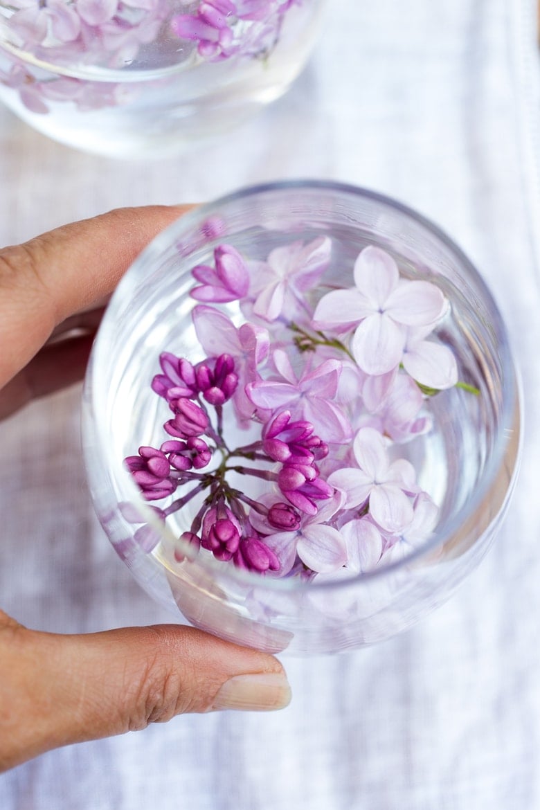 Lilac Water- water infused with lilac blossoms calms and restores the spirit. Perfect for weddings or celebrations, a lovely way to celebrate spring. | www.feastingathome.com #lilacwater