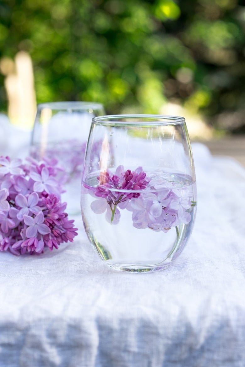 Lilac Water- water infused with lilac blossoms calms and restores the spirit. Perfect for weddings or celebrations, a lovely way to celebrate spring. | www.feastingathome.com #lilacwater