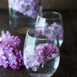 Lilac Water- water infused with lilac blossoms calms and restores the spirit. Perfect for weddings or celebrations, a lovely way to celebrate spring. | www.feastingathome.com #lilacwater #infused #lilacs #lilacrecipes #spring #infusedwater #water