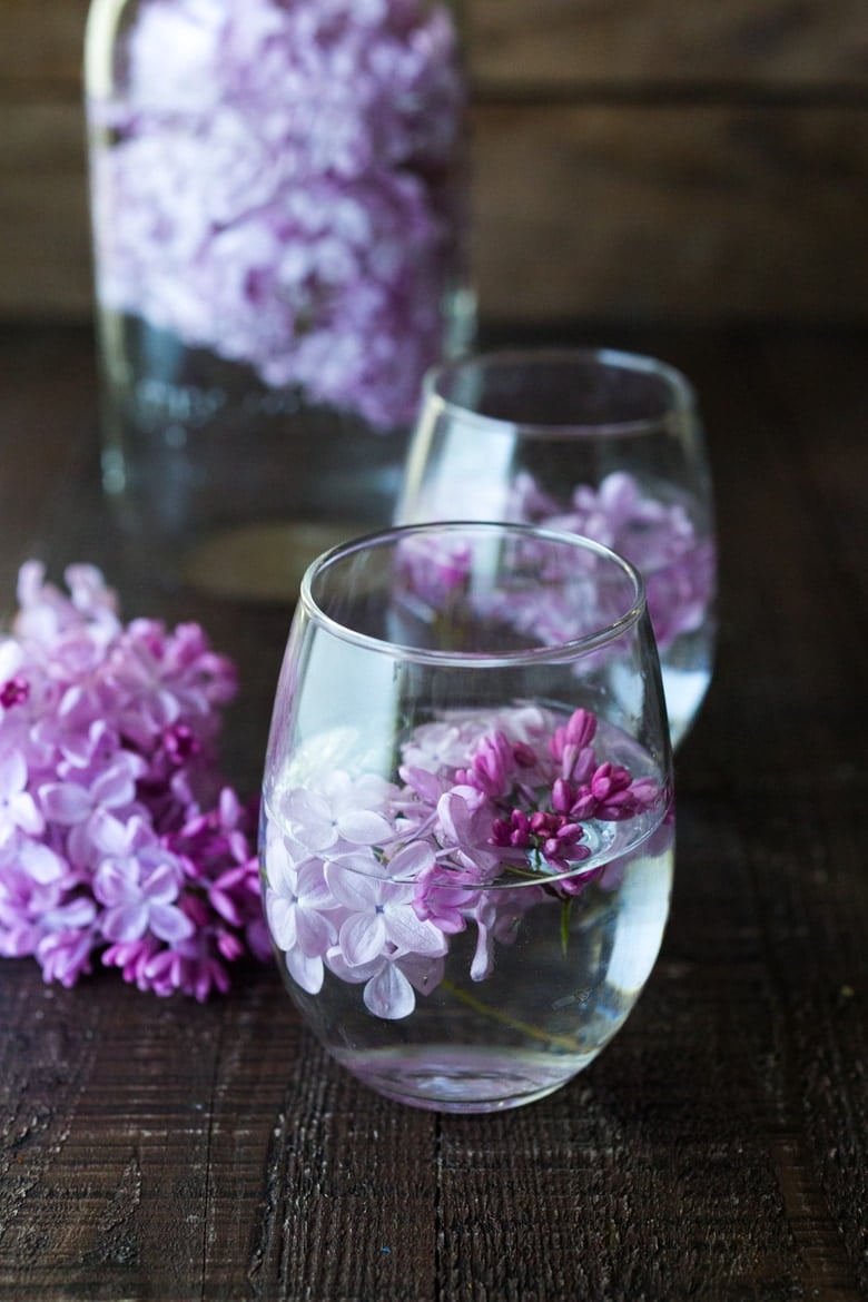 Lilac Water- water infused with lilac blossoms calms and restores the spirit. Perfect for weddings or celebrations, a lovely way to celebrate spring. | www.feastingathome.com #lilacwater