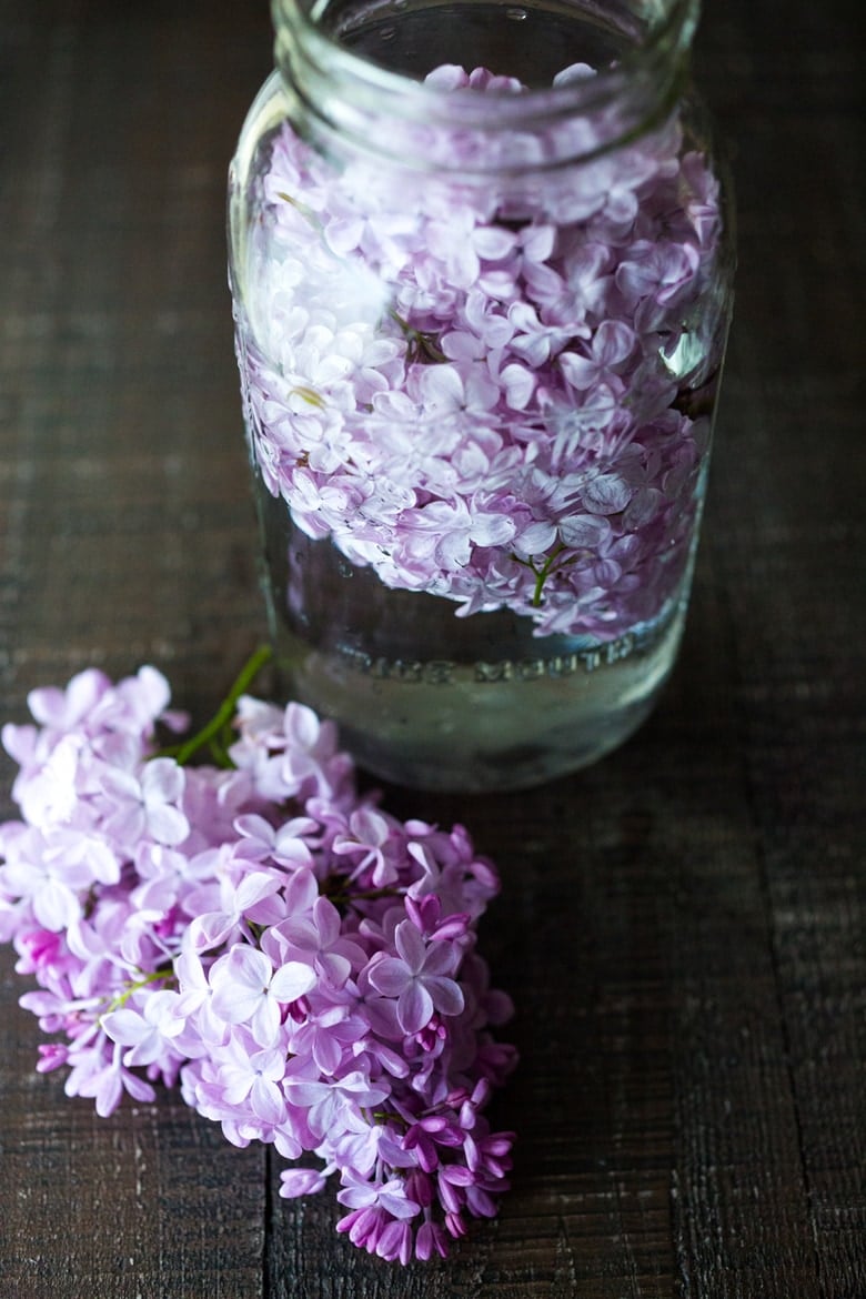 Lilac Water- water infused with lilac blossoms calms and restores the spirit. Perfect for weddings or celebrations, a lovely way to celebrate spring. | www.feastingathome.com #lilacwater