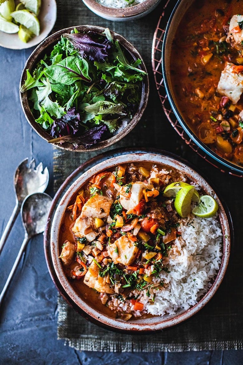 A simple Brazilian Fish Stew called Moqueca made with your choice of fish, simmered in coconut milk with onion, tomatoes, chilies and lime. Easy, fast and full of flavor! Serve this with rice! #Moqueca #fishstew #brazilianfishstew 