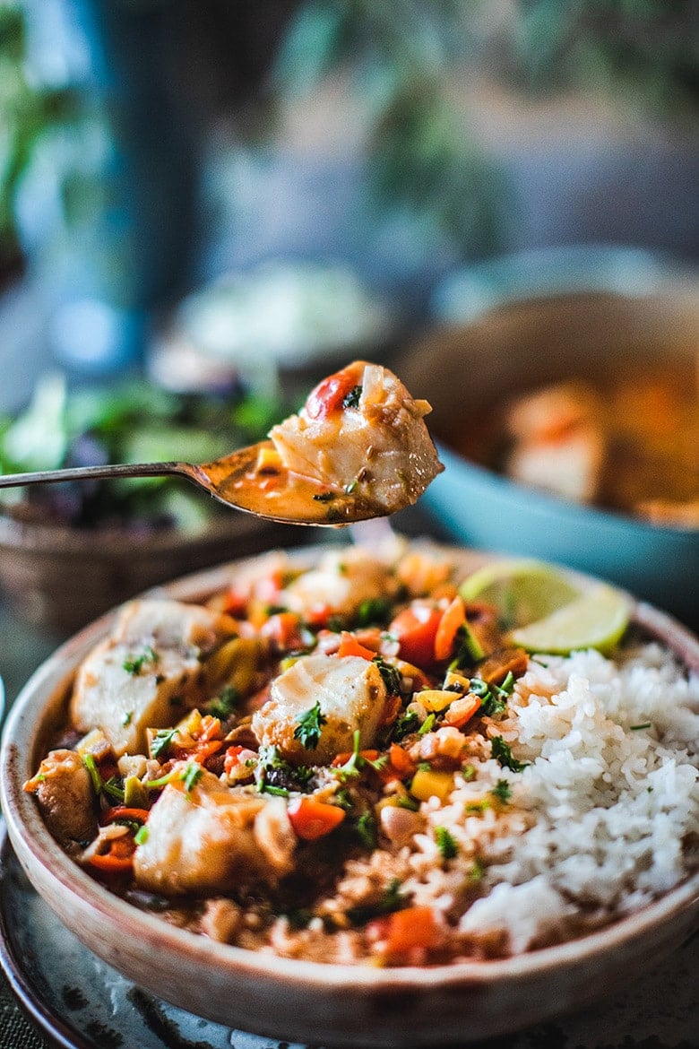 A simple Brazilian Fish Stew called Moqueca made with your choice of fish, simmered in coconut milk with onion, tomatoes, chilies and lime. Easy, fast and full of flavor! Serve this with rice! #Moqueca #fishstew #brazilianfishstew 