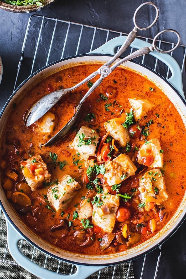 A simple Brazilian Fish Stew called Moqueca made with your choice of fish, simmered in coconut milk with onion, tomatoes, chilies and lime. Easy, fast and full of flavor! Serve this with rice! #Moqueca #fishstew #brazilianfishstew 