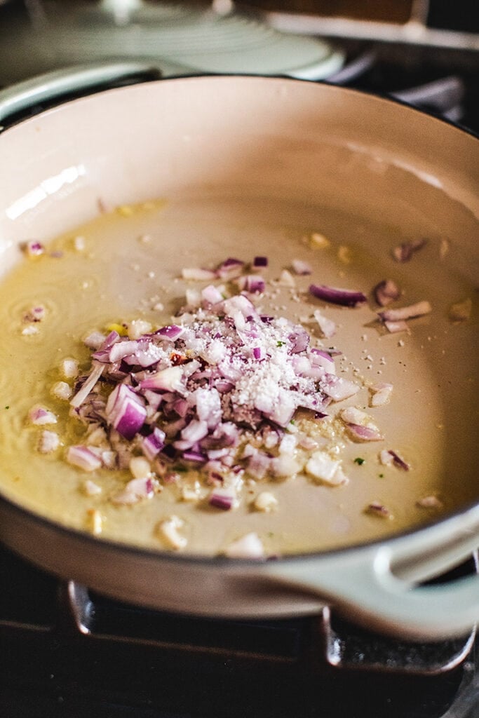 diced onions in pan with oil and salt. 