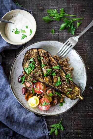 Za'taar Eggplant with fresh tomatoes, tahini or yogurt sauce and cooked grain. A healthy vegan gluten-free meal.
