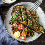 Zataar Roasted Eggplant with fresh tomatoes, tahini or yogurt sauce and cooked grain. A healthy vegan gluten-free meal.