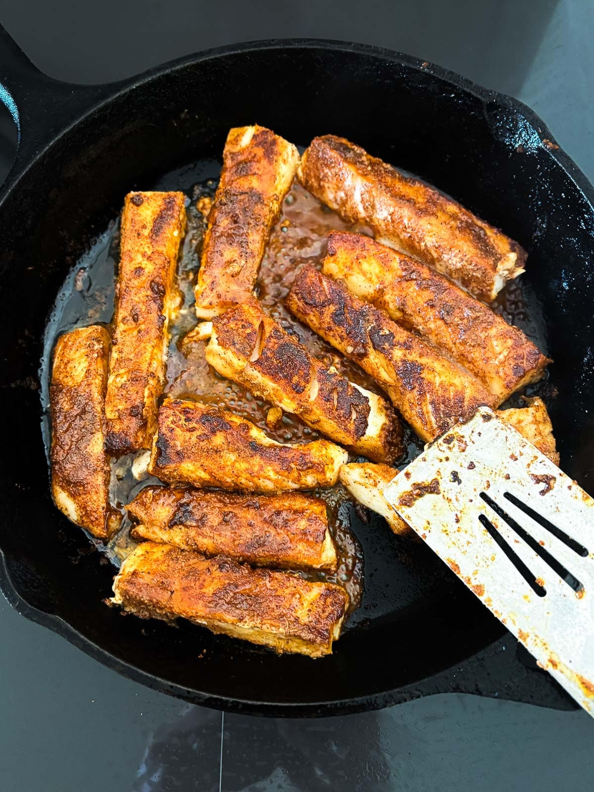 pan searing fish in a skillet for fish tacos. 