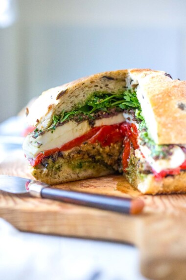 How to make a vegetarian Muffuletta Sandwich with grilled vegetables, pesto, mozzarella cheese, and Olive Tapenade. Great for picnics or summer gatherings.