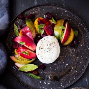 Burrata Salad with nectarines, summer tomatoes, fresh basil, creamy burrata cheese and a balsamic vinaigrette dressing. 