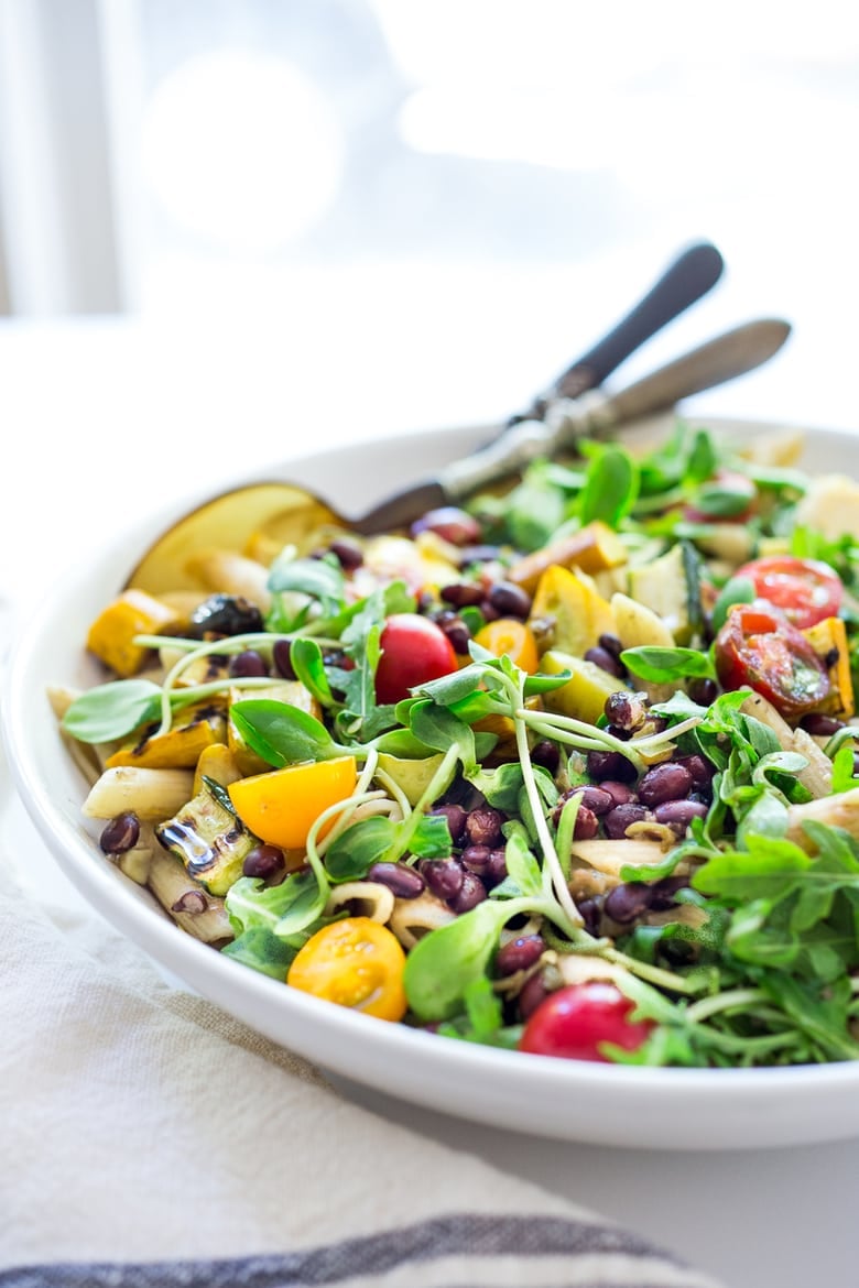Farmers Market Pasta Salad with grilled zucchini, corn and blackbeans or other veggies! Make with optional grain-free pasta and keep it vegan or add feta. | www.feastingathome.com