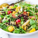 Summer Pasta with Grilled zucchini and summer squash, corn, black beans and cherry tomatoes! Serve this warm for dinner and save the rest for weekday lunches! www.feastingathome.com