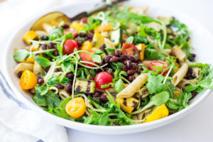 Summer Pasta with Grilled zucchini and summer squash, corn, black beans and cherry tomatoes! Serve this warm for dinner and save the rest for weekday lunches! www.feastingathome.com